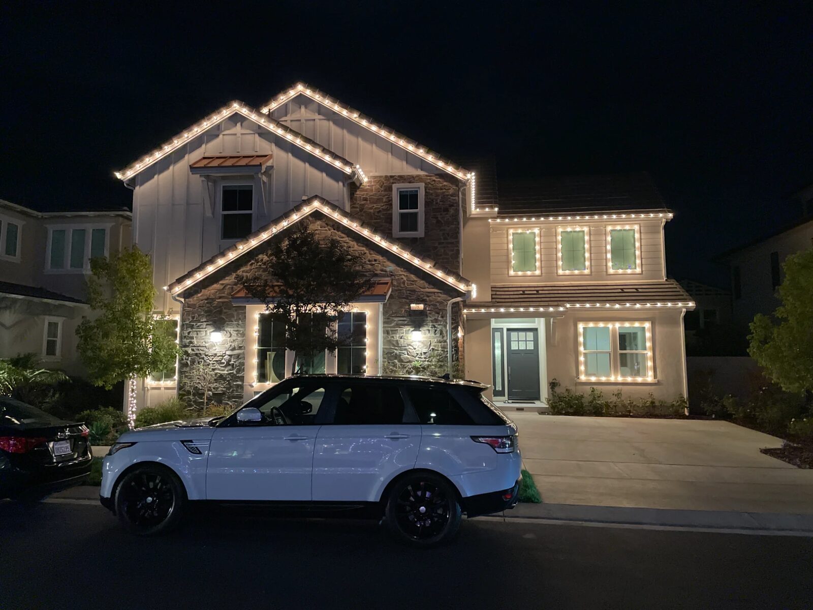 Two-story home with warm white roofline and window outlines