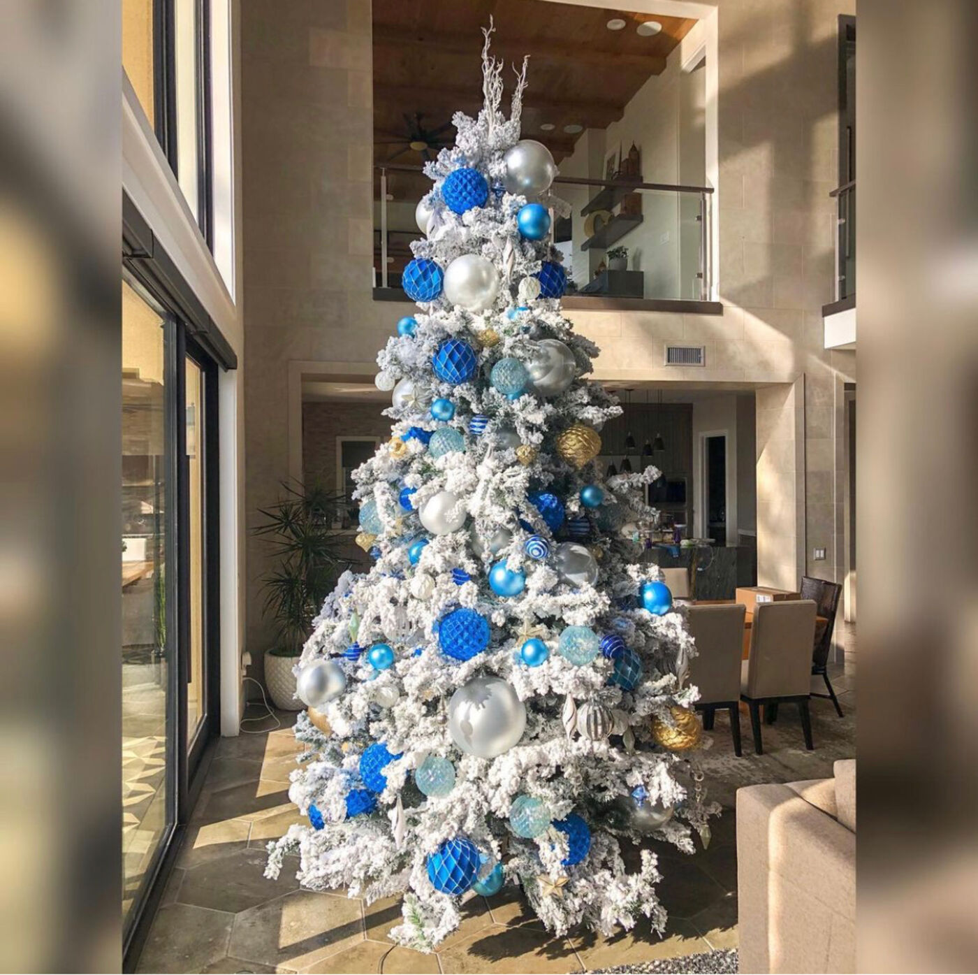 Flocked Christmas tree with blue and silver ornaments