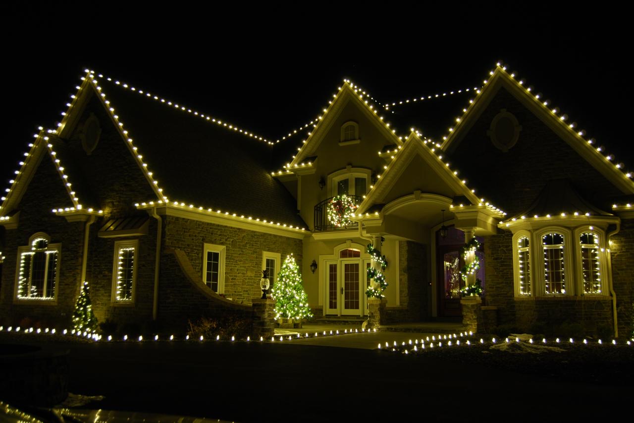 Two-story home with warm white lights outlining every gable